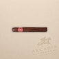 Arcadia Cigars Arturo Fuente Don Carlos Double Robusto cigar with an African Cameroon wrapper on a beige background.