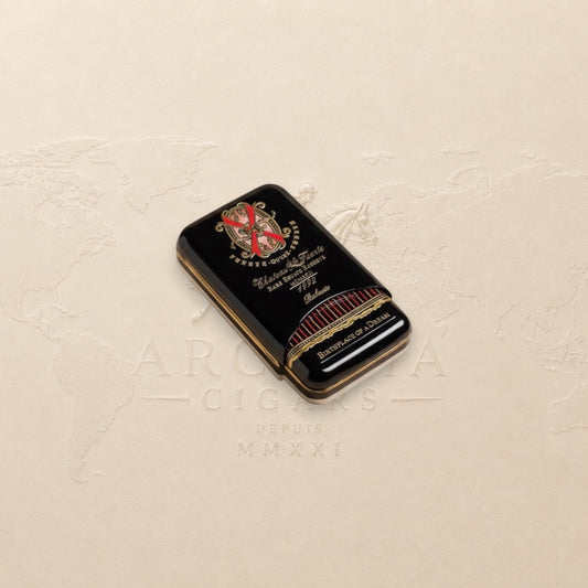 Arcadia Cigars Arturo Fuente Opus X Robusto cigar tin, black with gold lettering and red accents.