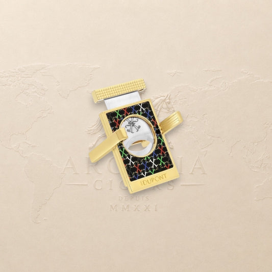 Arcadia Cigars S.T. Dupont gold cigar cutter with black face, red, white, green, blue X pattern, and textured grip.