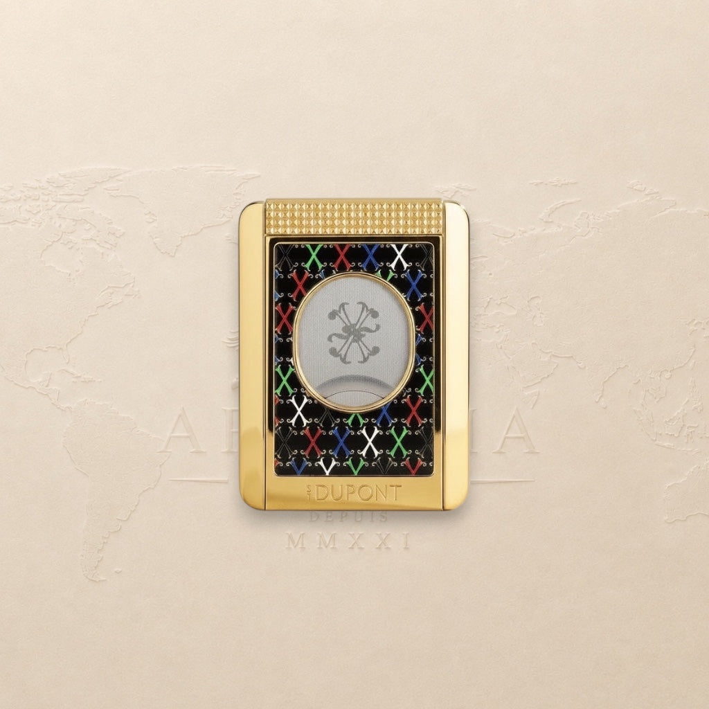 Arcadia Cigars S.T. Dupont gold cigar cutter with black face, red, white, green, blue X pattern, and textured grip.