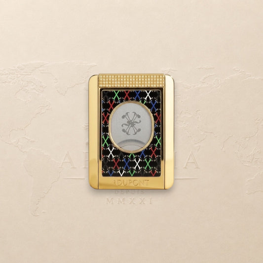 Arcadia Cigars S.T. Dupont gold cigar cutter with black face, red, white, green, blue X pattern, and textured grip.